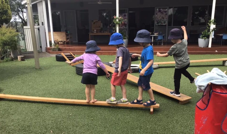 Children walking along balance beams