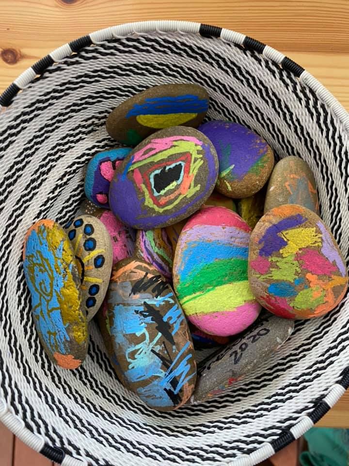 A basket of rocks painted by the children