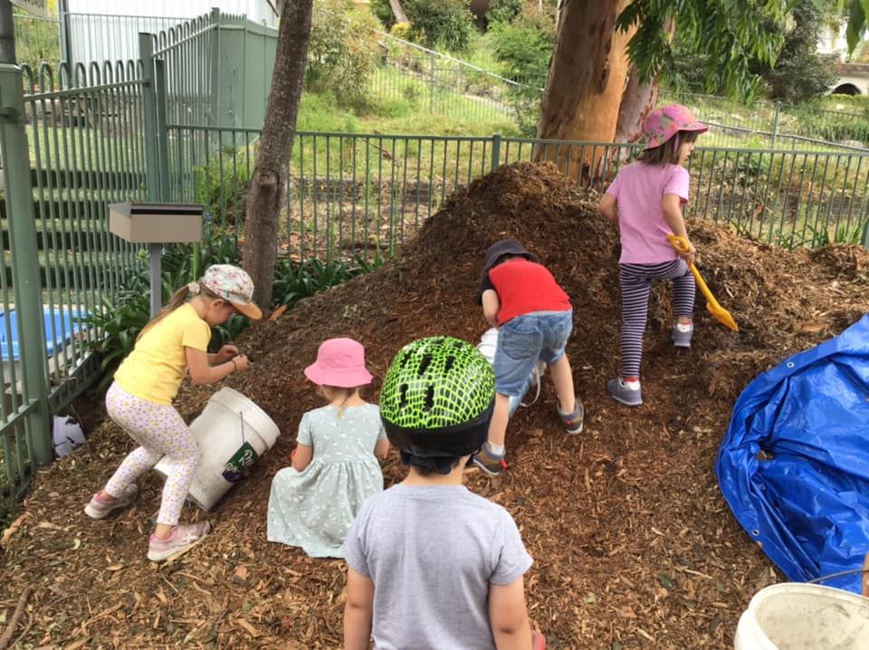 Children digging on a mound of soil