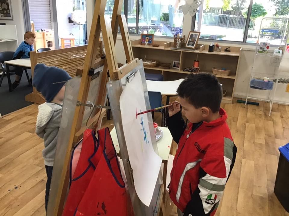Children painting at easels