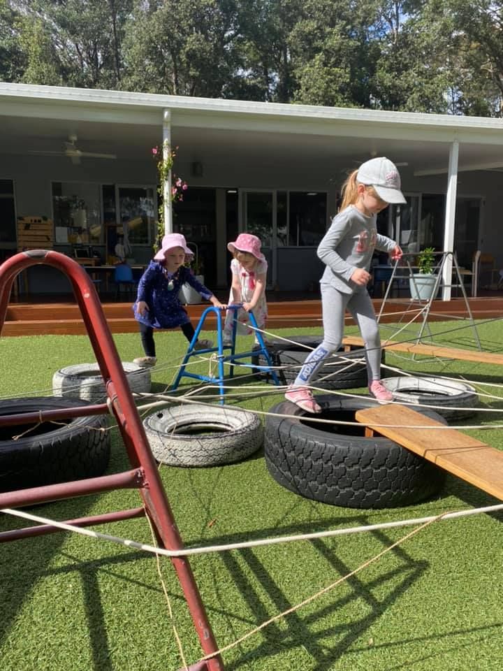 Children balancing on tyres and planks